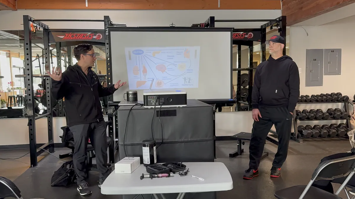 Dr. Andrew Simon presenting a health talk at a Seattle gym