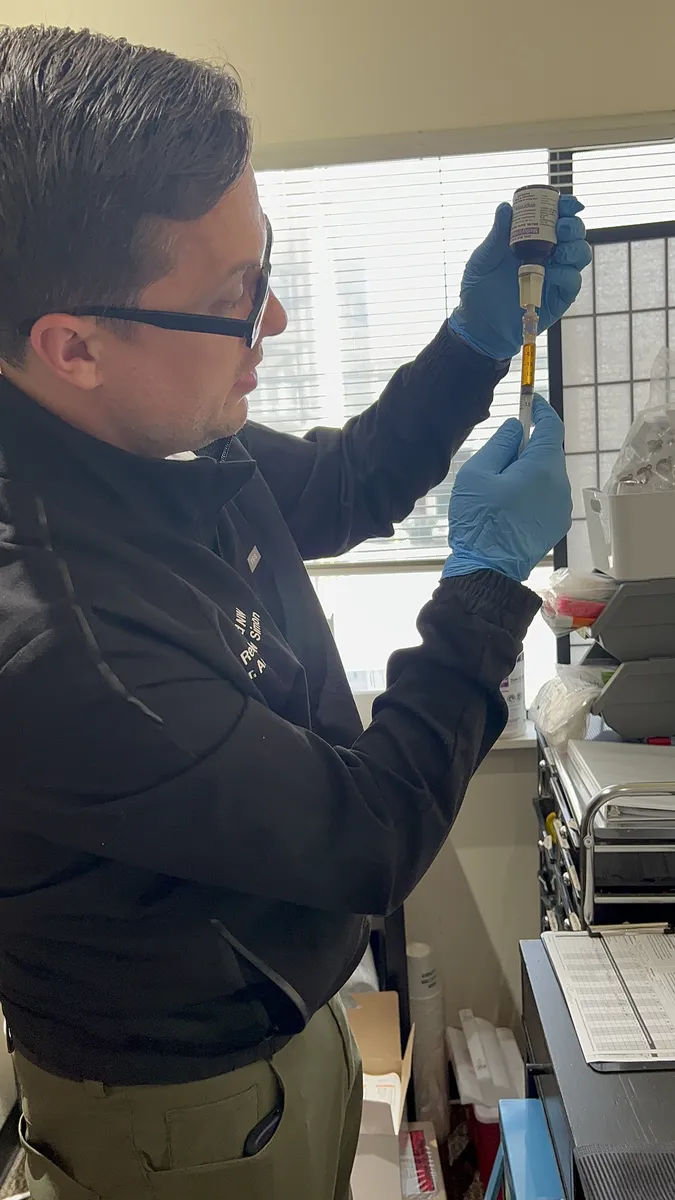 Dr. Andrew Simon drawing up a vitamin injection