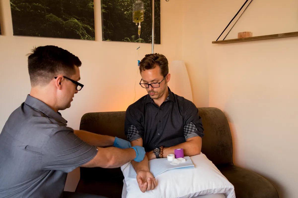 Dr. Andrew Simon administering IV nutrient therapy to a patient at Rebel Med NW