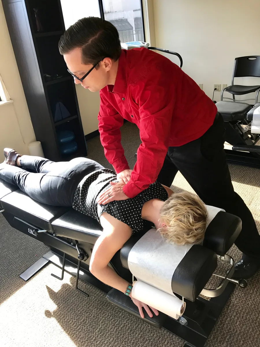 Dr. Andrew Simon performing a spinal adjustment on a patient at Rebel Med NW