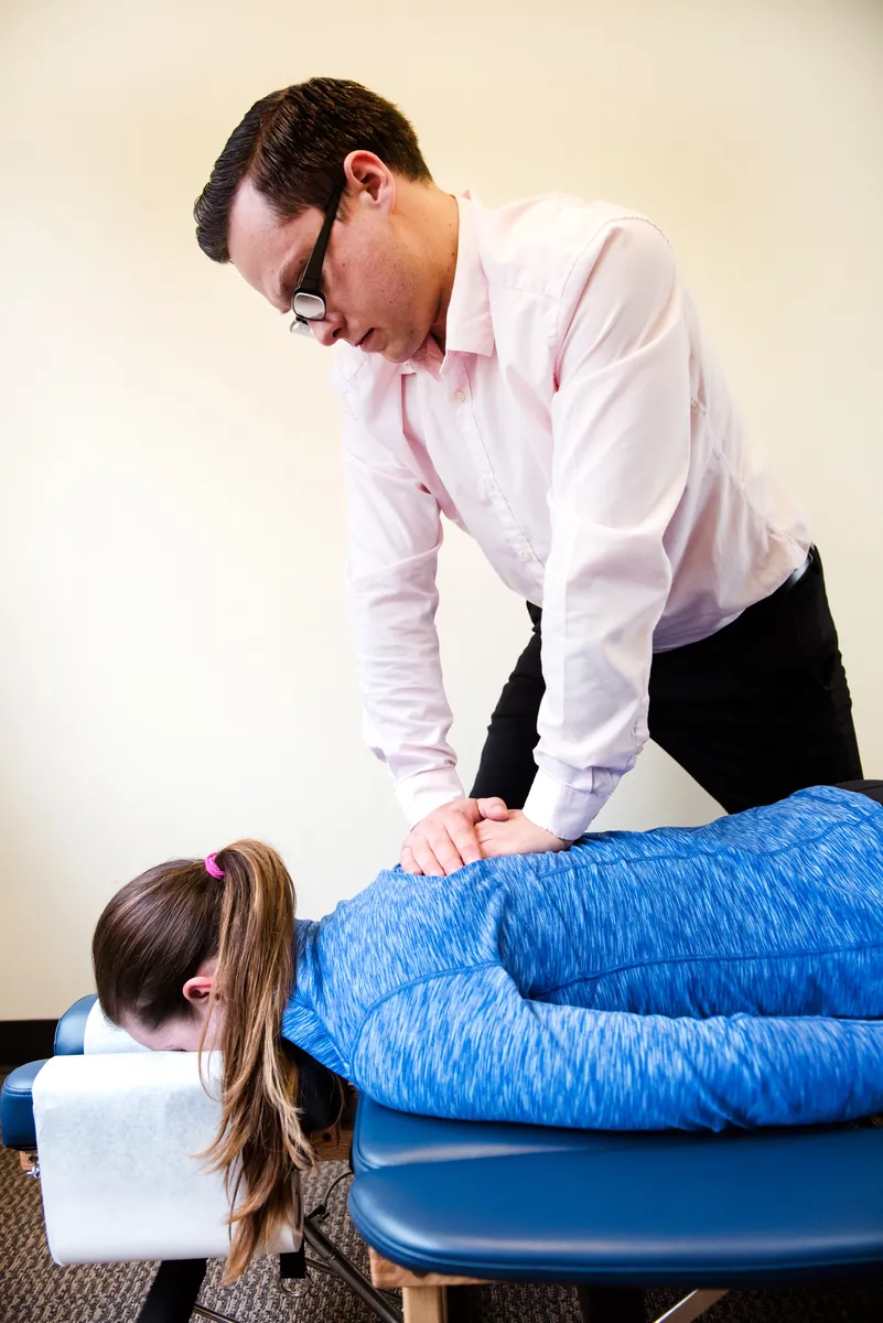 Dr. Simon performing a spinal adjustment on a patient
