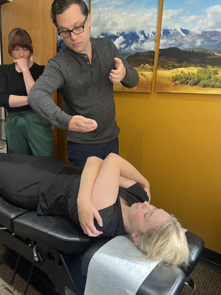 Dr. Andrew Simon demonstrating an adjustment technique to a mentee at Rebel Med NW