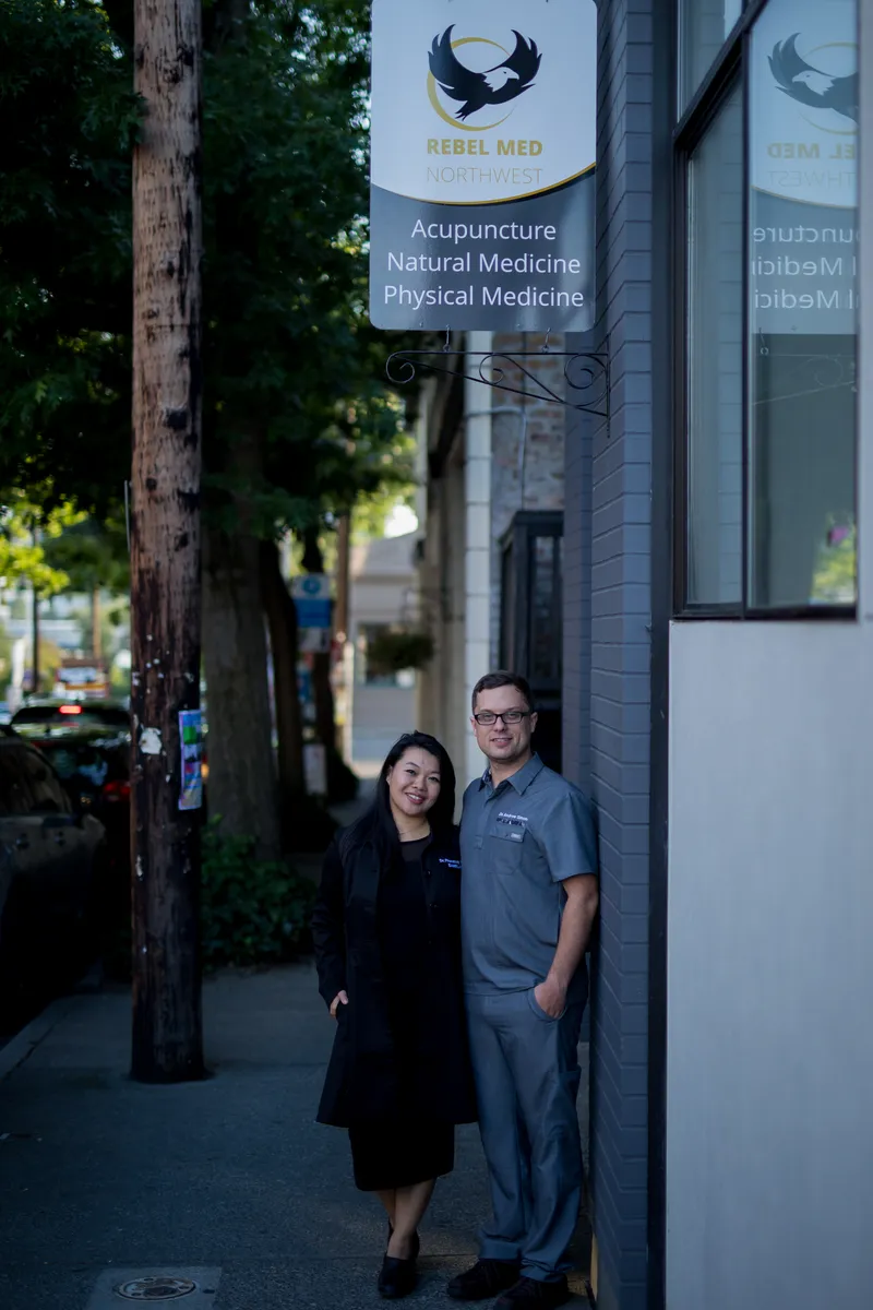 Clinic owners Dr. Andrew Simon and Dr. Phonexay Simon on the sidewalk outside Rebel Med NW in Ballard, Seattle